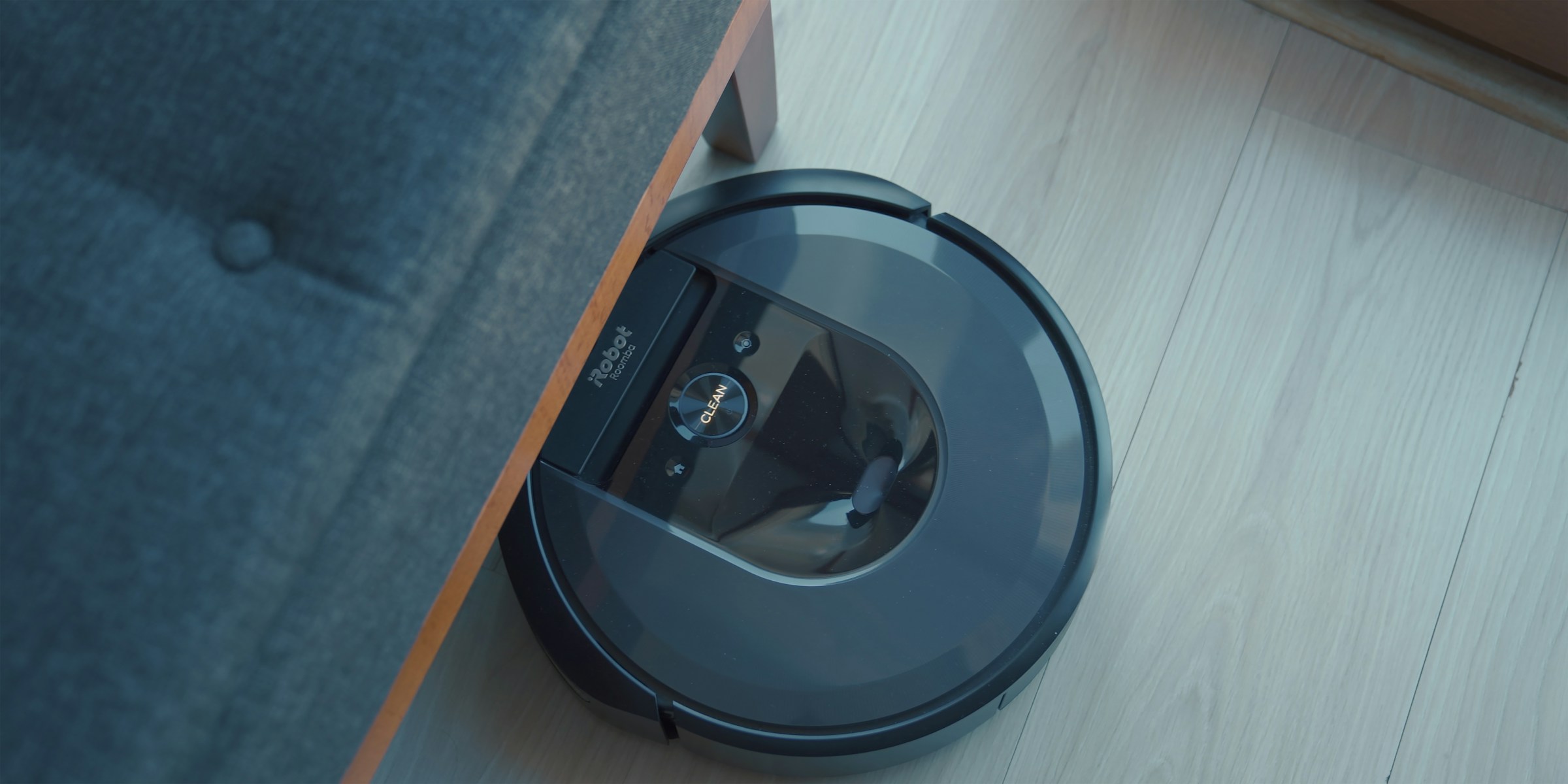 A futuristic robotic vacuum cleaner efficiently cleans the floor of a room, showcasing the benefits of smart appliances in enhancing home efficiency.